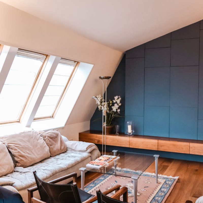 A cozy living room featuring blue walls and a comfortable couch, creating a serene and inviting atmosphere.