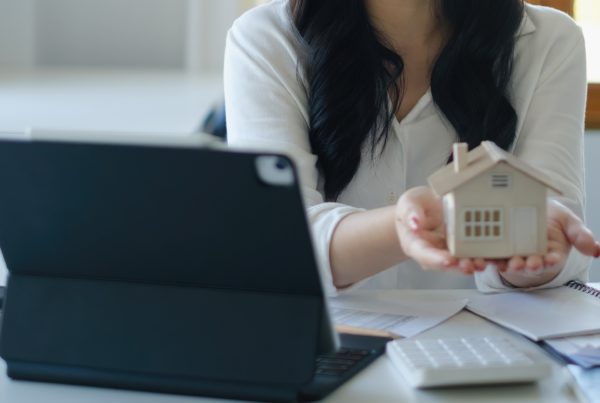 Asian Business woman or agent giving house after signing agreement for buying house. Bank manager and real estate concept.