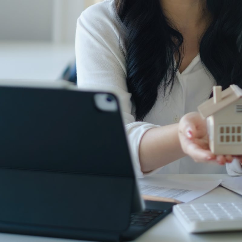 Asian Business woman or agent giving house after signing agreement for buying house. Bank manager and real estate concept.